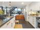 Modern kitchen with stainless steel appliances, white cabinetry, and an open layout to the second floor at 1203 24Th St, Denver, CO 80205