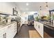 Modern kitchen with stainless steel appliances, white cabinetry, and geometric tile flooring at 1203 24Th St, Denver, CO 80205