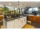Stylish kitchen island features black granite countertops and modern white cabinetry at 1203 24Th St, Denver, CO 80205
