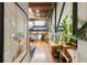 Spacious living room boasts hardwood floors, an area rug, a staircase to the loft, plants, artwork and metal structural beams at 1203 24Th St, Denver, CO 80205
