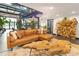 Bright open living room with exposed duct work, hardwood floors, large leather couch and natural wood coffee table at 1203 24Th St, Denver, CO 80205