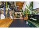 Open-concept living room with high ceilings, exposed beams, and open staircase to upstairs office at 1203 24Th St, Denver, CO 80205