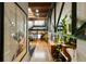 Bright living room with hardwood floors, exposed beams, stairs, and iron supports at 1203 24Th St, Denver, CO 80205