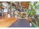 Large open floor plan with hardwood flooring, wrought iron staircase, fish tank and multiple plants at 1203 24Th St, Denver, CO 80205