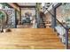 Open floor plan with hardwood flooring, open staircase and living area with desk and chairs at 1203 24Th St, Denver, CO 80205
