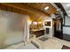 Bright bathroom with tile floors, modern vanity, glass shower, and a wood-beam ceiling at 1203 24Th St, Denver, CO 80205