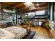 Open-concept main bedroom with hardwood floors, exposed wood beams, and iron supports and stairs at 1203 24Th St, Denver, CO 80205