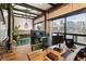 Bright and open work space features hardwood floors, brick accent wall, fish tank and desk with computers at 1203 24Th St, Denver, CO 80205