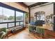Office space with brick accent wall, large window and hardwood floors at 1203 24Th St, Denver, CO 80205
