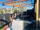 Relaxing outdoor patio area with seating, grilling area, and wood pergola, perfect for entertaining and lounging at 1203 24Th St, Denver, CO 80205