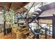 A multi-level metal staircase offers wooden treads and provides access to the home's loft, with plants and lighting nearby at 1203 24Th St, Denver, CO 80205