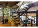 Open-concept staircase with black iron railing, hardwood steps, and exposed beams at 1203 24Th St, Denver, CO 80205