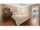 Comfortable bedroom featuring hardwood floors, a classic dresser, and a queen-sized bed at 1359 Chambers Rd, Aurora, CO 80011