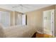 Serene bedroom with neutral walls, hardwood floors, ceiling fan, and an adjacent bathroom at 1359 Chambers Rd, Aurora, CO 80011