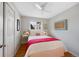 Inviting bedroom with wood floors, bright accents, and a large window at 1359 Chambers Rd, Aurora, CO 80011