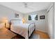 Cozy bedroom with hardwood floors, a wrought iron bed frame, and ample natural light at 1359 Chambers Rd, Aurora, CO 80011