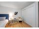 Cozy bedroom featuring a soft chair, storage drawers, and a closet for a comfortable and organized space at 1359 Chambers Rd, Aurora, CO 80011