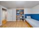 Well-organized bedroom with built-in bed, bookshelf and door to another room at 1359 Chambers Rd, Aurora, CO 80011