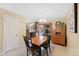 Bright dining area with tile flooring and a view of the kitchen and sunroom through sliding doors at 1359 Chambers Rd, Aurora, CO 80011