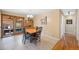 Cozy dining area features a dining table, tile flooring, and sliding doors leading to a sunroom at 1359 Chambers Rd, Aurora, CO 80011