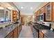 Clean kitchen featuring stainless steel appliances, ample cabinet space, tile floors, and a bright dining area at 1359 Chambers Rd, Aurora, CO 80011