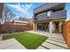 Backyard featuring well-maintained lawn, concrete patio, and contemporary home design, perfect for outdoor enjoyment at 2223 W 34Th Ave, Denver, CO 80211