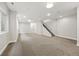 Bright, spacious finished basement with neutral carpet, recessed lighting, and staircase to the upper level at 2223 W 34Th Ave, Denver, CO 80211