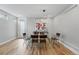 Bright dining room with hardwood floors, modern lighting, and adjacent to kitchen at 2223 W 34Th Ave, Denver, CO 80211