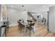 Open-concept dining room with hardwood floors, modern lighting, leading into the kitchen at 2223 W 34Th Ave, Denver, CO 80211