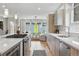 Bright kitchen featuring stainless steel appliances, quartz countertops, and view to the living room at 2223 W 34Th Ave, Denver, CO 80211