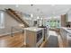 Bright, open kitchen featuring a central island with modern appliances and view to the living room at 2223 W 34Th Ave, Denver, CO 80211