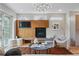 Cozy living room featuring a fireplace, built-in shelving, and natural light from the windows at 2223 W 34Th Ave, Denver, CO 80211