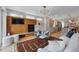 Open-concept living room with fireplace, TV, and view into the kitchen at 2223 W 34Th Ave, Denver, CO 80211