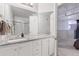 Bright bathroom featuring a granite countertop vanity and a glass-enclosed shower at 1555 California St # 414, Denver, CO 80202