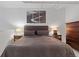 Comfortable bedroom features a large bed, side tables with lamps, and a chest of drawers, creating a relaxing space at 1555 California St # 414, Denver, CO 80202