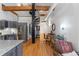 Open floor plan with kitchen, living room, and desk area, connected by a spiral staircase and exposed beams at 1555 California St # 414, Denver, CO 80202