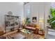 Bright living room featuring a comfortable leather couch, a stylish glass coffee table, and eclectic shelving at 1555 California St # 414, Denver, CO 80202