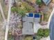 Birds eye view of property with mature trees, solar panels, landscaped yard, and driveway at 7676 S Olive Cir, Centennial, CO 80112