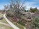 Stunning aerial view showcasing the house, mature trees, green lawn and proximity to a walking trail at 7676 S Olive Cir, Centennial, CO 80112