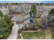 Aerial perspective of home with mature trees, driveway, solar panels, and manicured lawn at 7676 S Olive Cir, Centennial, CO 80112