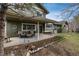 Covered patio with outdoor seating overlooking the beautifully landscaped backyard at 7676 S Olive Cir, Centennial, CO 80112