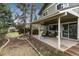 Landscaped backyard with a covered patio and lush greenery at 7676 S Olive Cir, Centennial, CO 80112