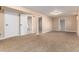 Spacious finished basement with neutral carpet and ample storage space at 7676 S Olive Cir, Centennial, CO 80112