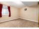 Finished basement bonus room with neutral carpet and good lighting at 7676 S Olive Cir, Centennial, CO 80112