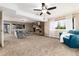 Basement living room features a cozy stone fireplace and ample natural light at 7676 S Olive Cir, Centennial, CO 80112