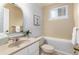 A charming bathroom with a vanity, toilet, tub, and floral wallpaper at 7676 S Olive Cir, Centennial, CO 80112