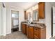 Well-appointed bathroom features double vanity, granite countertops, and a separate toilet room at 7676 S Olive Cir, Centennial, CO 80112