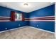 Cozy bedroom features a blue painted accent wall with white and red stripes at 7676 S Olive Cir, Centennial, CO 80112