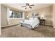 Comfortable bedroom features a ceiling fan, a large window and neutral tones for a relaxing atmosphere at 7676 S Olive Cir, Centennial, CO 80112