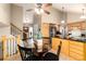 Cozy dining area adjacent to the kitchen featuring a glass table, and a view of the living room at 7676 S Olive Cir, Centennial, CO 80112